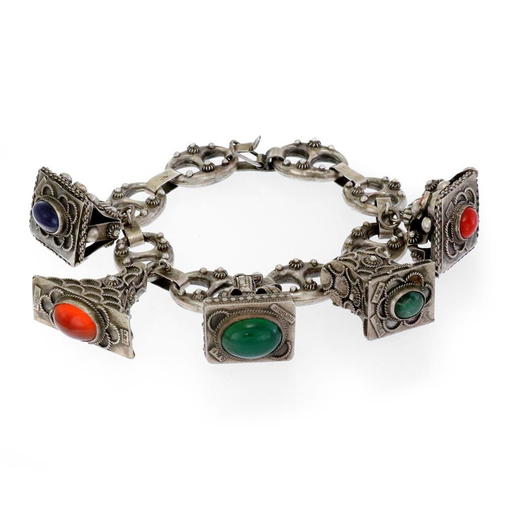 Etruscan Silver Charm Bracelet S&F with Multicolor Gemstones: Etruscan Silver Charm Bracelet S&F with Multicolor Gemstones Discover the elegance of this vintage Etruscan Silver Charm Bracelet, meticulously crafted from sterling silver with a unique patina. This 