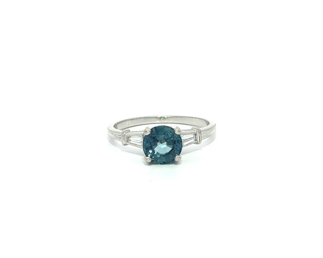 Vintage Platinum 1.24ct GIA Round Sapphire Baguette Diamond Ring: Vintage Platinum 1.24ct GIA Round Sapphire Baguette Diamond Ring This exquisite vintage ring showcases a stunning 1.12ct natural round step cut sapphire, prong set in solid .900 platinum. The sapphire