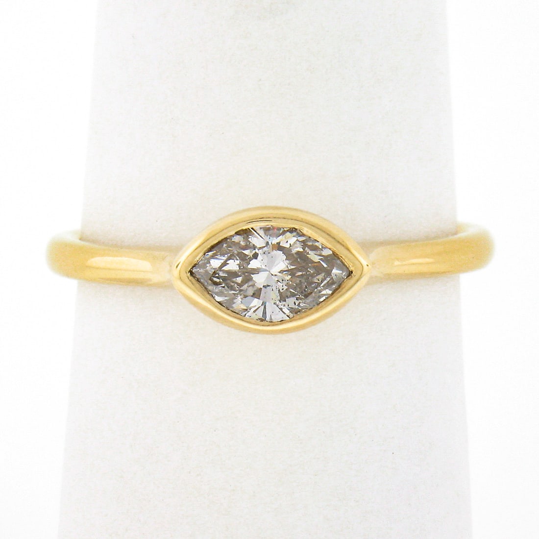 14k Yellow Gold 0.53ctw Marquise Bezel Set Diamond Solitaire Ring: 14k Yellow Gold 0.53ctw Marquise Bezel Set Diamond Solitaire Ring This exquisite 14k Yellow Gold Marquise Bezel Diamond Solitaire Ring features a stunning natural diamond, weighing 0.53 carats, showca