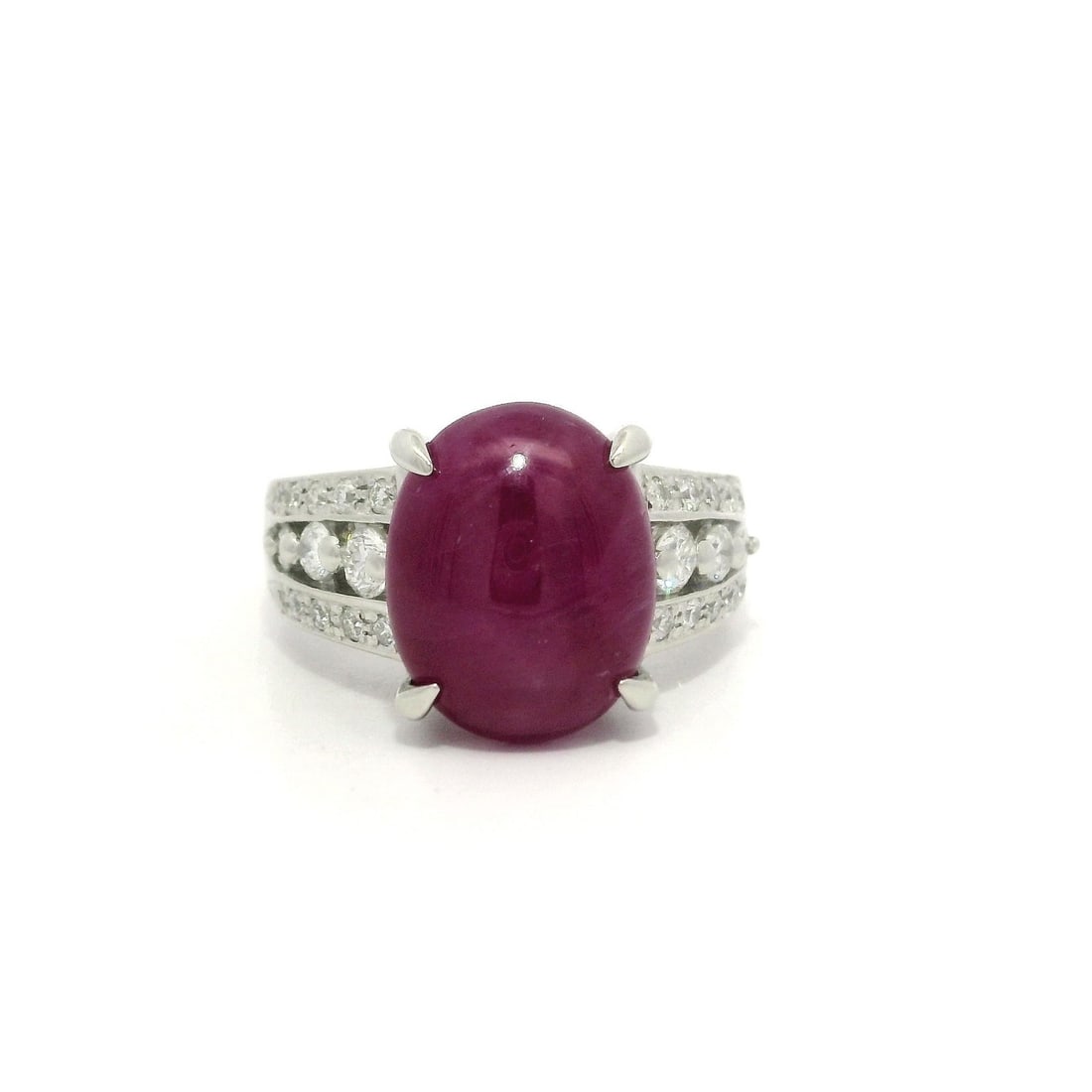 Platinum 0.44ctw Diamond Cocktail Ring with Natural Star Ruby: Platinum 0.44ctw Diamond Cocktail Ring with Natural Star Ruby This stunning cocktail ring features a large oval cabochon star ruby, showcasing its natural pinkish-red color and unique star effect. The