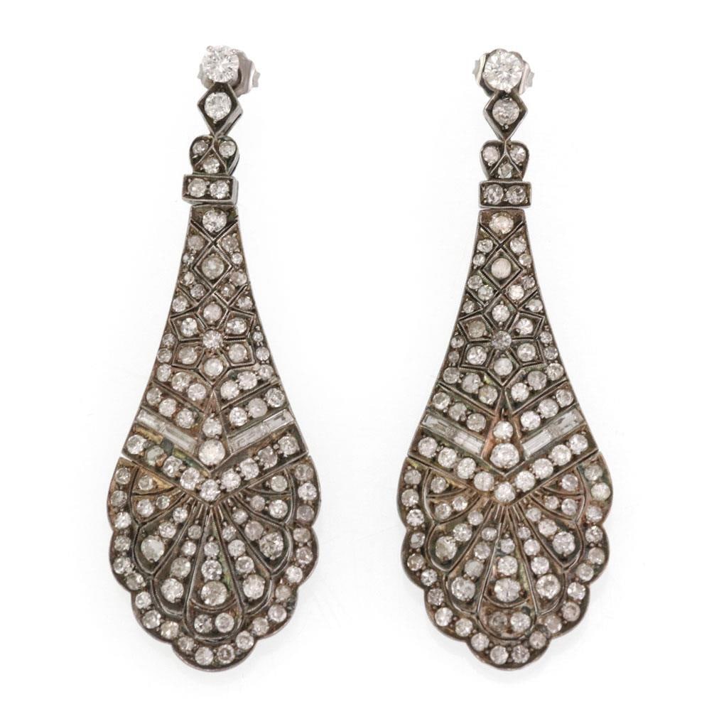 Antique Sterling Silver 5ct Diamond Long Chandelier Earrings: Antique Sterling Silver 5ct Diamond Long Chandelier Earrings These exquisite antique chandelier earrings are elegantly crafted from sterling silver, showcasing a stunning long petal-like design. Adorn