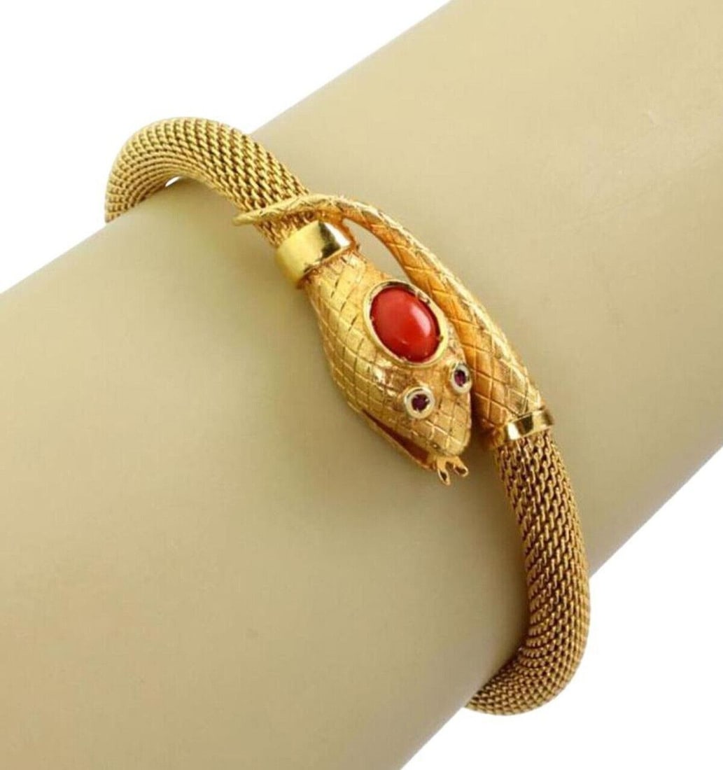 Vintage 18k Yellow Gold Snake Mesh Cuff Bracelet with Coral Accent: Vintage 18k Yellow Gold Snake Mesh Cuff Bracelet with Coral Accent This vintage estate bracelet is crafted in 18k yellow gold with a mesh construction and a coral snake-inspired cuff design. It featur