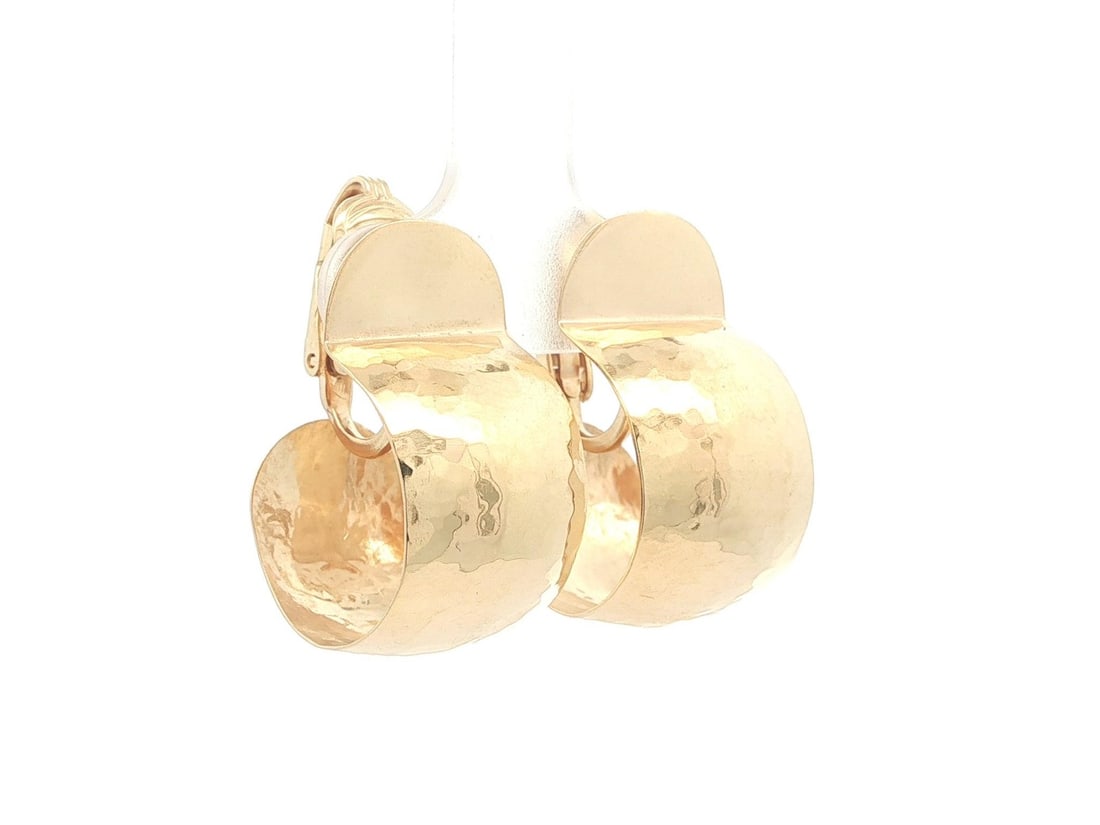 Wide Hammered 14k Yellow Gold Vintage Clip On Cuff Earrings: Wide Hammered 14k Yellow Gold Vintage Clip On Cuff Earrings These vintage wide cuff clip-on earrings are crafted from solid 14k yellow gold with a distinctive hammered finish. Designed for women, they