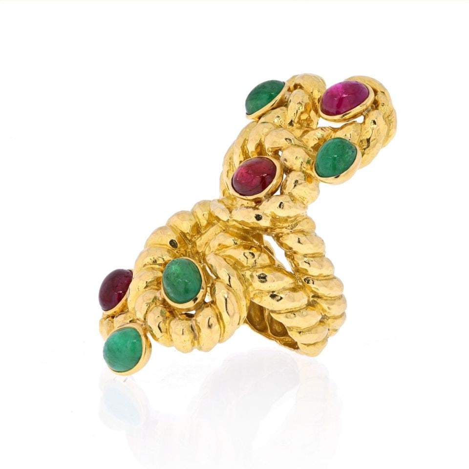 Serpent Motif Ring in Platinum and 18K Gold with Ruby and Emerald by David Webb: Serpent Motif Ring in Platinum and 18K Gold with Ruby and Emerald by David Webb This stunning David Webb ring showcases a serpentine design crafted from 18K yellow gold. The ring features a cabochon r