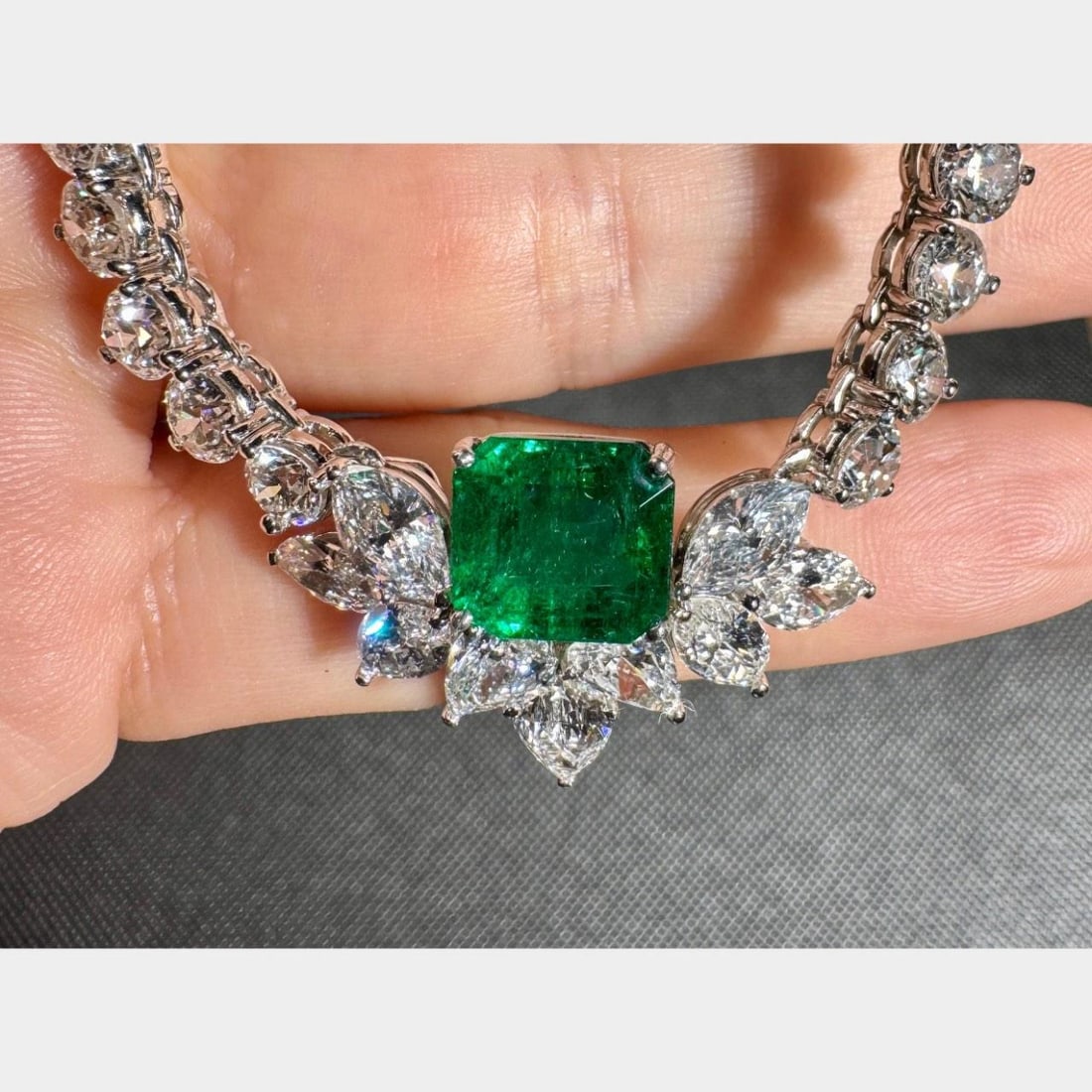 1950's Platinum Necklace with 4.18 Ct Emerald and 37 Diamonds: 1950's Platinum Necklace with 4.18 Ct Emerald and 37 Diamonds This stunning 1950's Platinum Emerald & Diamond Necklace showcases exquisite craftsmanship and elegance. It features a gorgeous 4.18 Ct. e