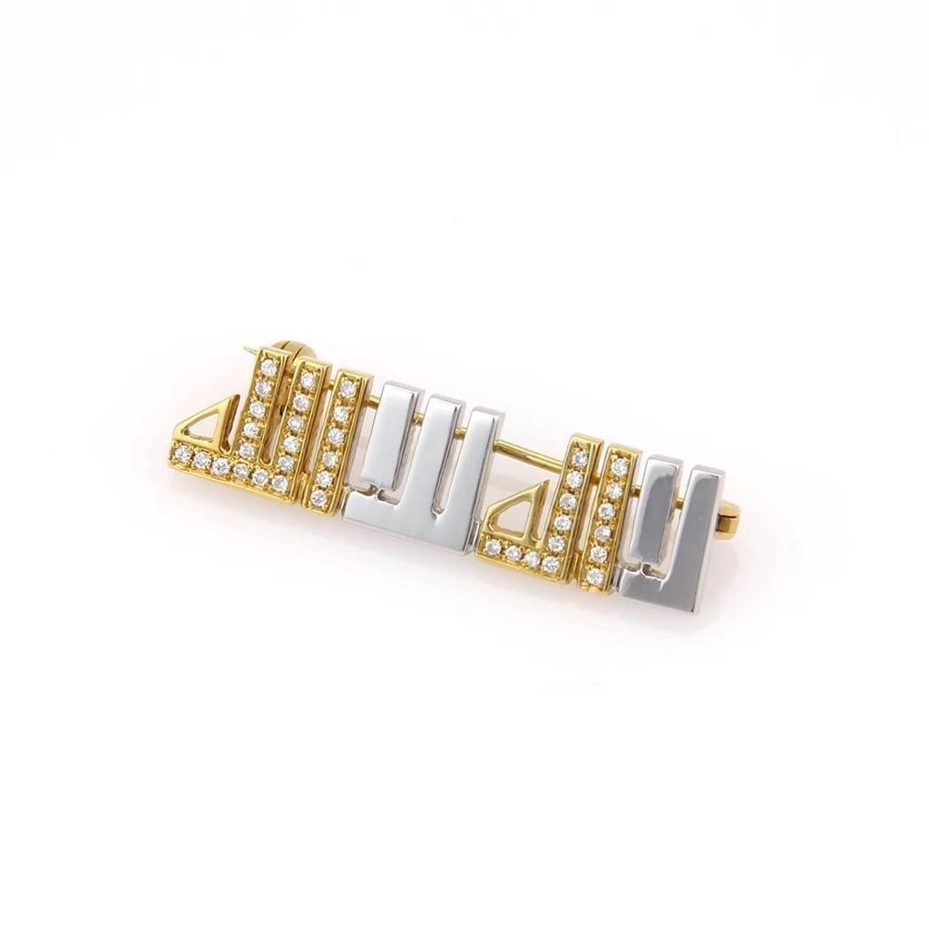 Vintage 18k Two Tone Gold Arabic Script Diamond Brooch Pin: Vintage 18k Two Tone Gold Arabic Script Diamond Brooch Pin This vintage estate brooch is crafted in 18k two-tone gold and designed in Arabic script, accented with diamonds. It has a slender, refined s