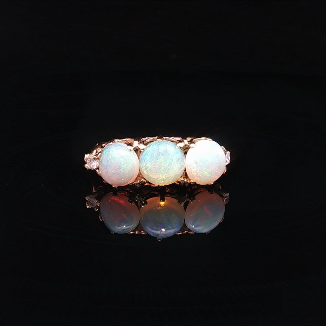 Vintage 14k Yellow Gold Opal Diamond Open Work Band Ring: Vintage 14k Yellow Gold Opal Diamond Open Work Band Ring This stunning vintage band ring showcases a captivating design crafted in solid 14k yellow gold. The centerpiece features three natural cabocho