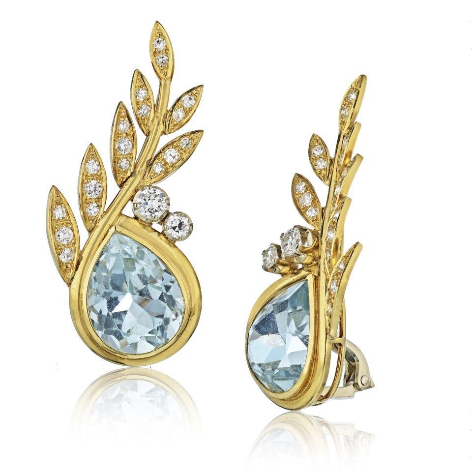 Stunning 18K Yellow Gold Aquamarine Diamond Clip-On Earrings: Stunning 18K Yellow Gold Aquamarine Diamond Clip-On Earrings These stunning earrings feature a luxurious design crafted from 18K yellow gold, showcasing an impressive total diamond weight of approxima