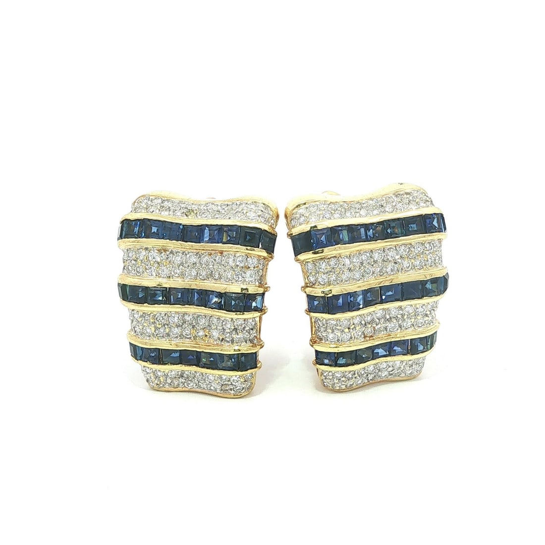 18k Yellow Gold Sapphire Diamond Cuff Earrings Flared Step Cut: 18k Yellow Gold Sapphire Diamond Cuff Earrings Flared Step Cut These elegant cuff earrings are crafted from solid 18k yellow gold and feature a striking combination of square step cut sapphires and ro