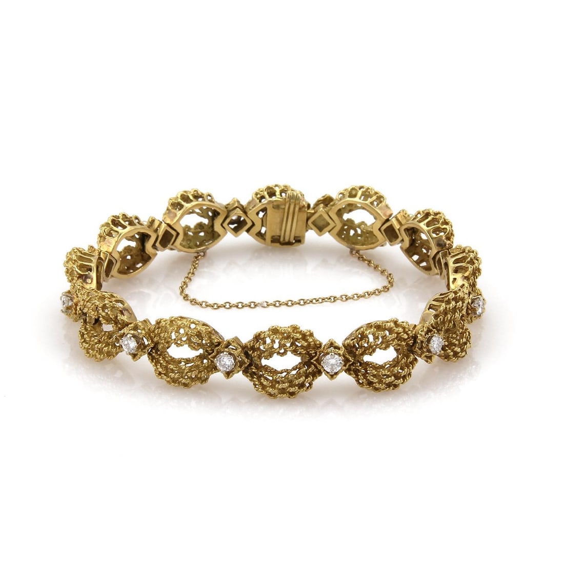 18k Yellow Gold 1.45ct Diamond Floral Link Bracelet: 18k Yellow Gold 1.45ct Diamond Floral Link Bracelet This exquisite bracelet showcases a stunning design crafted from 18k yellow gold, featuring a rough textured finish. The open floral links are enhan