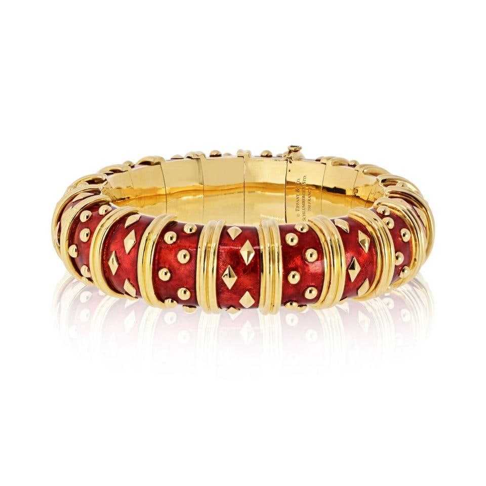 Schlumberger Red Enamel Dot Losange Bangle in 18K Yellow Gold: Schlumberger Red Enamel Dot Losange Bangle in 18K Yellow Gold This vintage Tiffany & Co. Schlumberger Dot Losange bangle bracelet showcases a geometric link design in 18K yellow gold, accented with vi