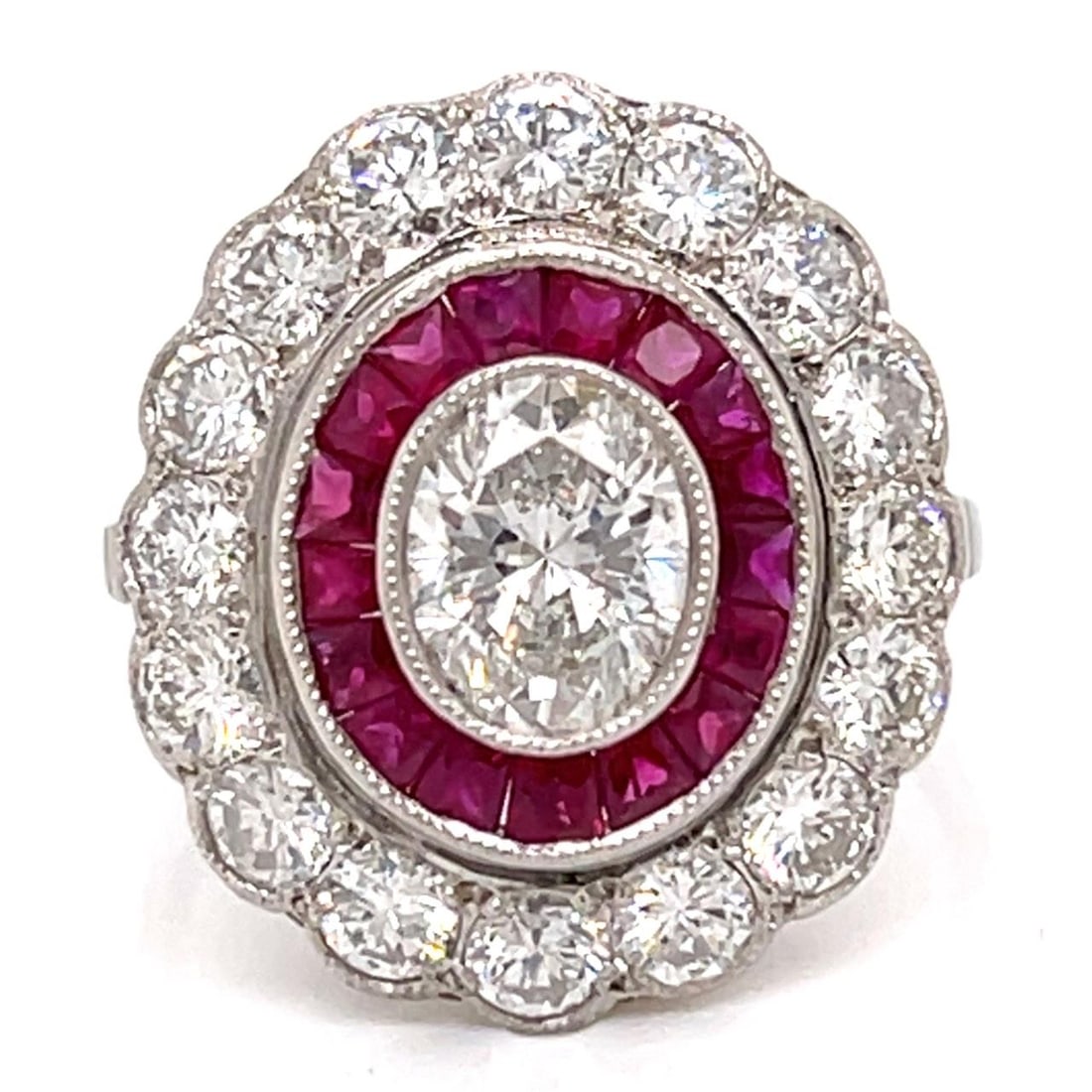 Platinum Ring Featuring Oval Diamond and Rubies Size 7.5: Platinum Ring Featuring Oval Diamond and Rubies Size 7.5 This platinum ring features an approximate 1.10 carat oval diamond with F-G color and SI1-SI2 clarity. It is accented by 23 diamonds totaling a