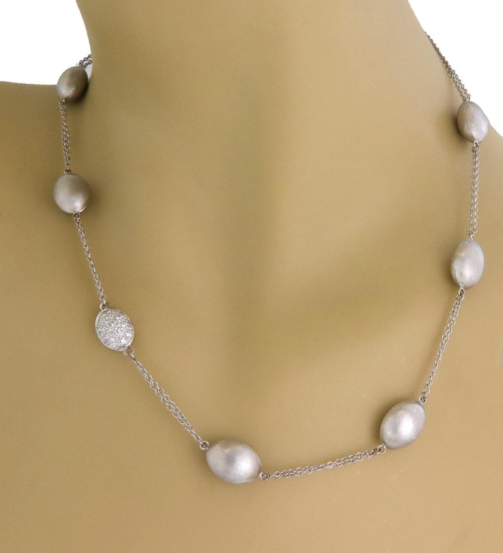 14k White Gold Double Chain Oval Bead Diamond Necklace: 14k White Gold Double Chain Oval Bead Diamond Necklace This exquisite necklace features a double chain design crafted from 14k white gold. The necklace showcases six satin finish oval beads, each meas