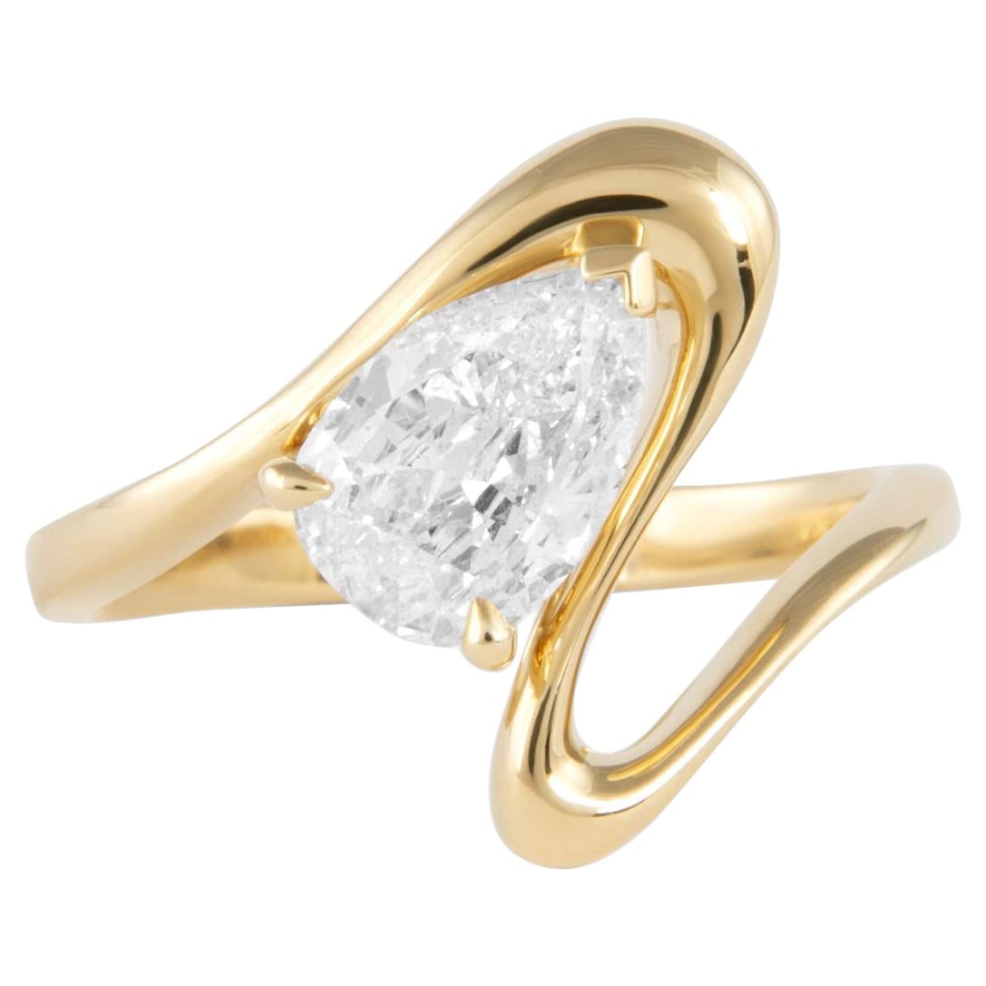 1.04ct Pear Cut Diamond Abstract Ring 18k Yellow Gold: 1.04ct Pear Cut Diamond Abstract Ring 18k Yellow Gold This exquisite 1.04ct pear diamond abstract ring is crafted in 18k yellow gold, showcasing a stunning contemporary design. The ring features a bri