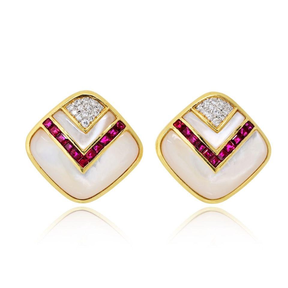 1980s 18K Yellow Gold Earrings With Mother Of Pearl Diamonds And Rubies: 1980s 18K Yellow Gold Earrings With Mother Of Pearl Diamonds And Rubies These circa 1980s earrings are crafted from 18K yellow gold and feature mother of pearl, diamond, and ruby accents. Designed as 