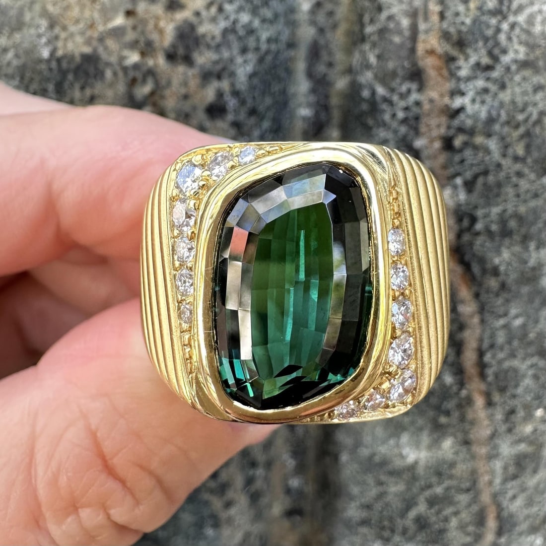 GIA Certified 18k Gold Ring with Blue Green Tourmaline and Diamond Accents: GIA Certified 18k Gold Ring with Blue Green Tourmaline and Diamond Accents This striking unisex ring features a unique flame modified step cut natural blue green tourmaline, weighing approximately 8 c