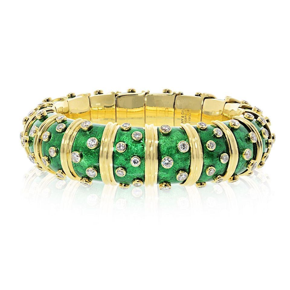 Schlumberger Green Enamel Diamond Bangle in 18K Gold by Tiffany & Co.: Schlumberger Green Enamel Diamond Bangle in 18K Gold by Tiffany & Co. This Tiffany & Co. Schlumberger bracelet is expertly crafted in 18K yellow gold and features luminous light green paillonne enamel