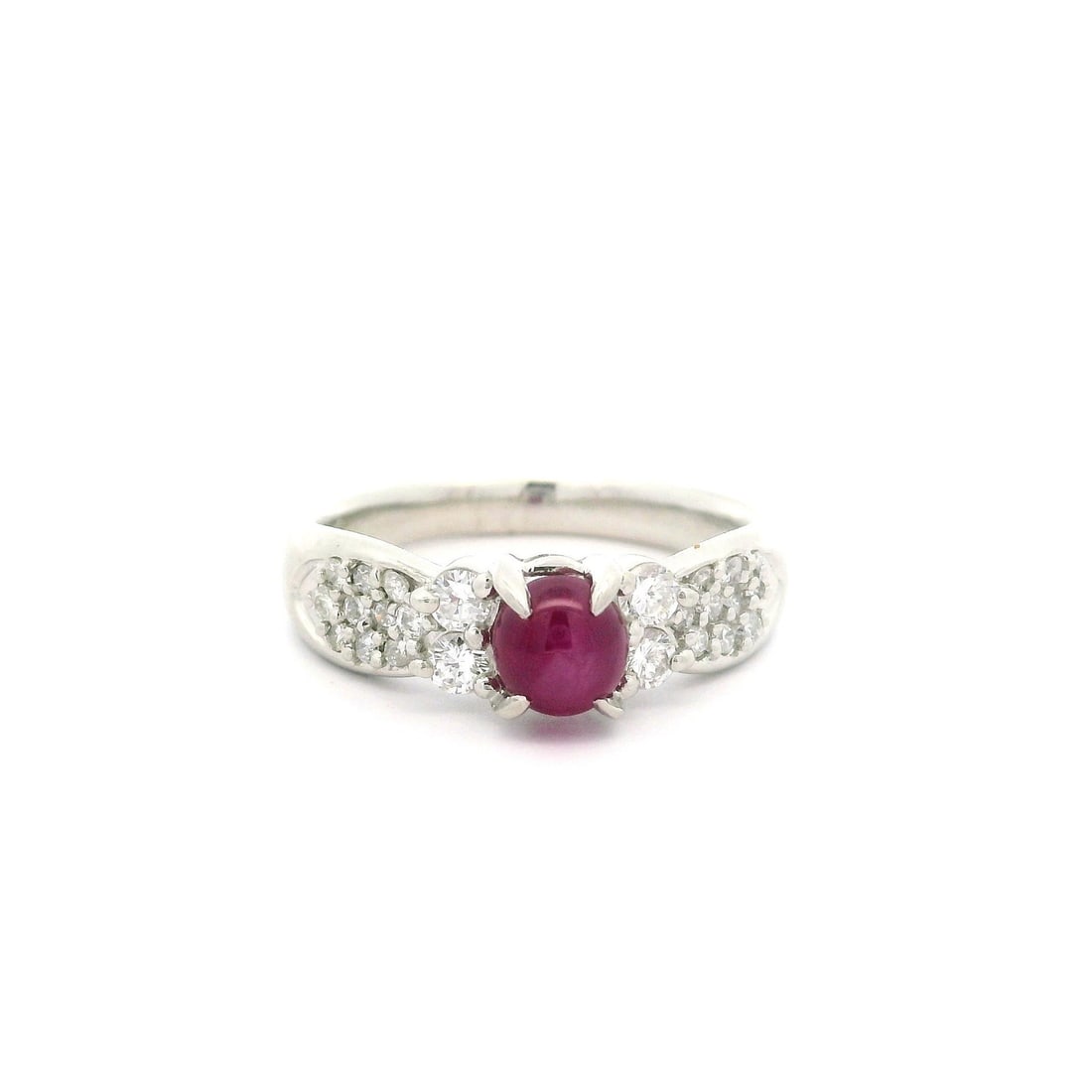 Vintage Platinum 1.54ctw Star Ruby & Diamond Elegant Ring: Vintage Platinum 1.54ctw Star Ruby & Diamond Elegant Ring This exquisite vintage ring features a stunning natural star ruby with an oval cabochon cut, showcasing a vivid red color. The ruby, weighing 