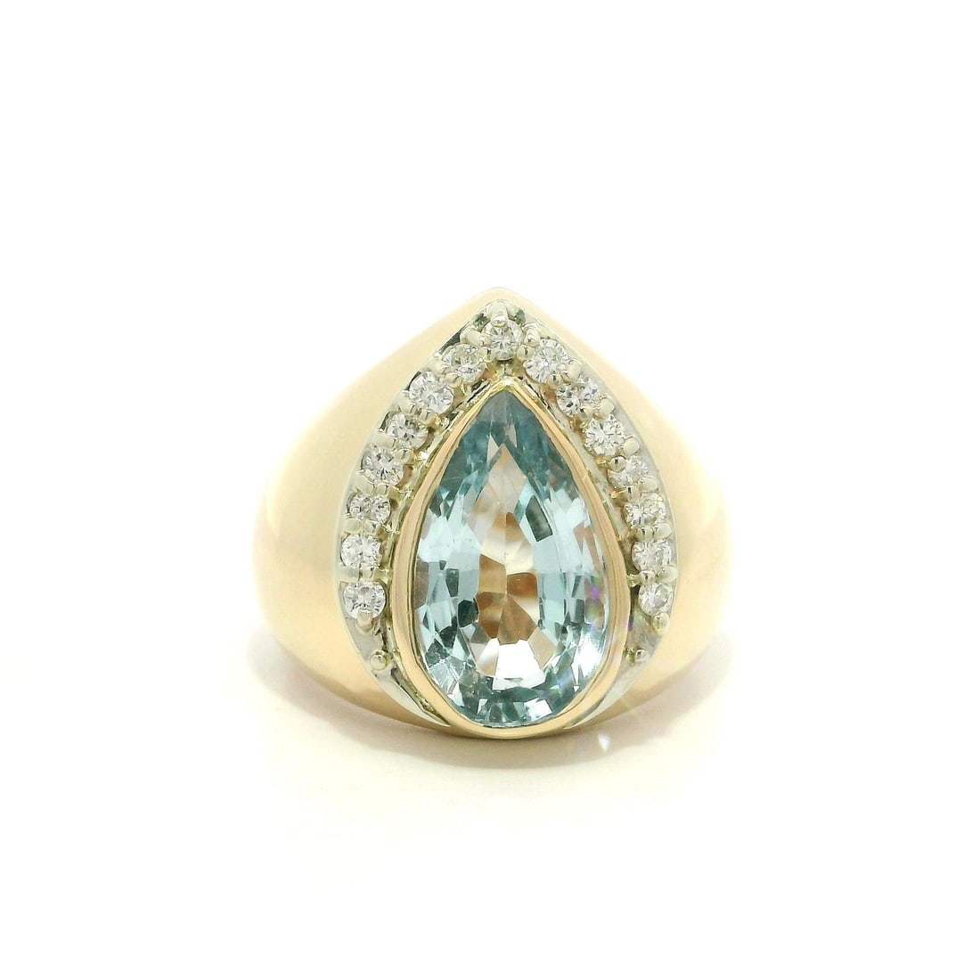 Wide Bombe Ring in 14k Yellow Gold with Pear Blue Topaz and Diamonds: Wide Bombe Ring in 14k Yellow Gold with Pear Blue Topaz and Diamonds This women's cocktail ring features a pear-shaped, natural blue topaz bezel set at the center, complemented by fifteen round brilli