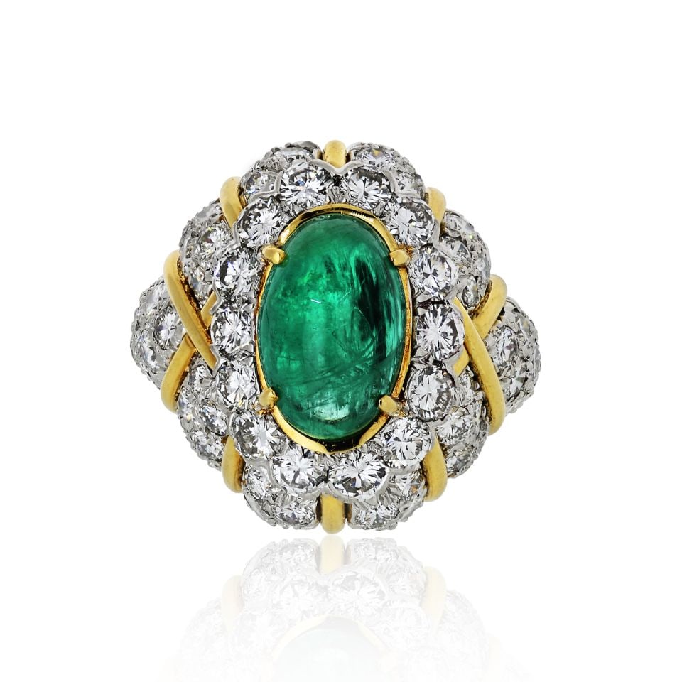 David Webb 18K Yellow Gold 6.54ct Emerald Diamond Cocktail Ring: David Webb 18K Yellow Gold 6.54ct Emerald Diamond Cocktail Ring This stunning David Webb ring showcases a captivating deep green emerald cabochon, elegantly surrounded by a halo of round brilliant whi