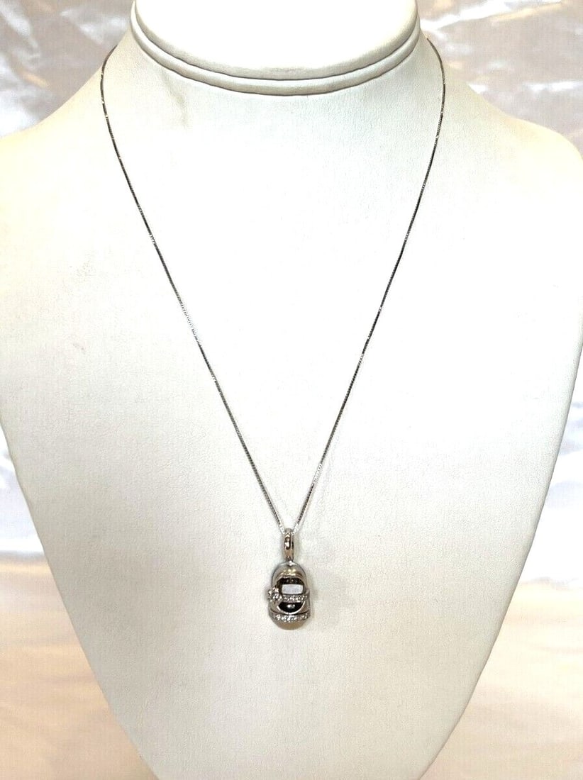 Aarom Basha shoe pendant necklace in platinum with diamonds: Aarom Basha shoe pendant necklace in platinum with diamonds A pre-owned Aarom Basha pendant necklace featuring a platinum shoe pendant set with diamond. The piece is fully signed and hallmarked, with 
