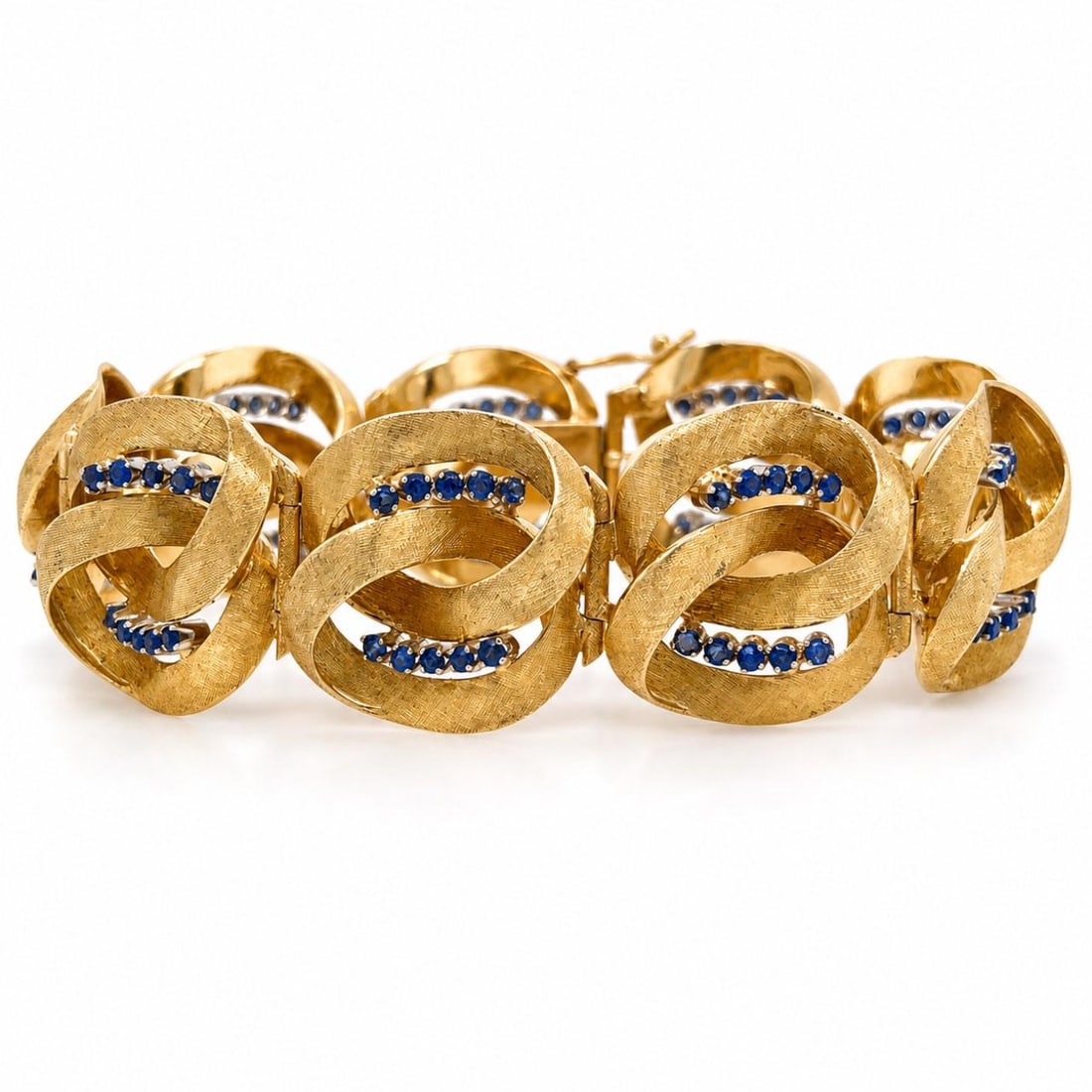 Vintage 18K Yellow Gold Bracelet with 90 Sapphires: Vintage 18K Yellow Gold Bracelet with 90 Sapphires This 1960s bracelet is crafted from 18K yellow gold and features 90 sapphires with a total approximate weight of 4.00 carats. The bracelet measures 8
