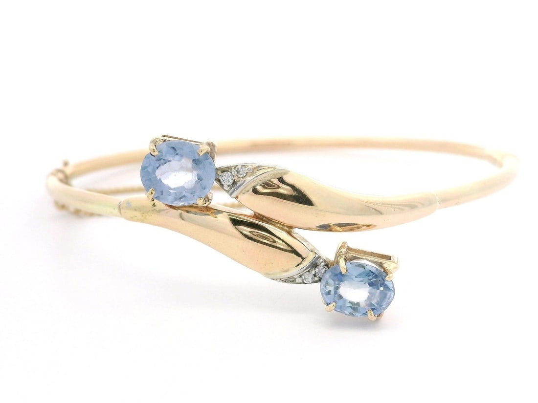 14k Gold 2.55ct Ceylon Sapphire Diamond Bypass Bangle Bracelet: 14k Gold 2.55ct Ceylon Sapphire Diamond Bypass Bangle Bracelet This exquisite hinged bypass bangle bracelet features two stunning natural Ceylon periwinkle sapphires, each oval cut and prong set, tota