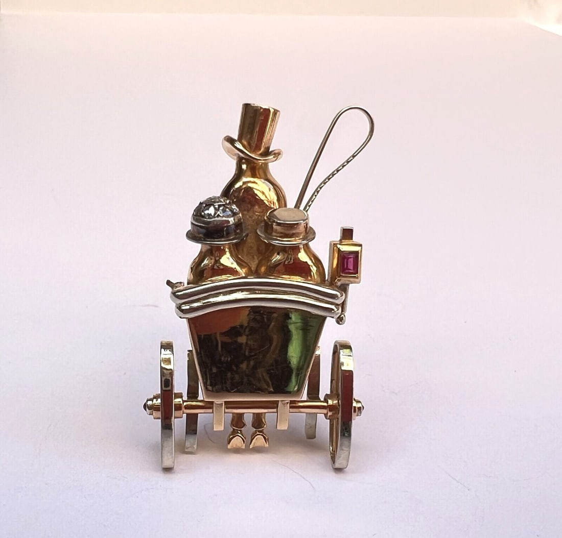 Exquisite French 18K Gold Diamond Ruby Carriage Brooch: Exquisite French 18K Gold Diamond Ruby Carriage Brooch This exquisite French brooch showcases a stunning carriage design crafted from 18K yellow and white gold. Adorned with both diamonds and rubies, 