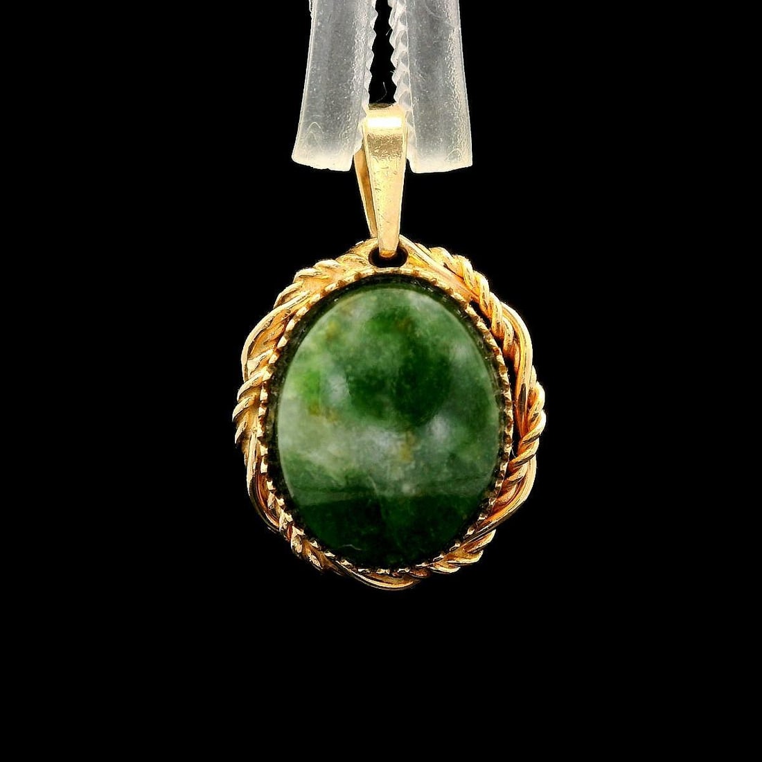 14k Yellow Gold Petite Twisted Green Jade Charm Pendant: 14k Yellow Gold Petite Twisted Green Jade Charm Pendant This exquisite charm pendant showcases a genuine oval green jade stone, elegantly framed in 10k yellow gold. The jade, measuring approximately 9