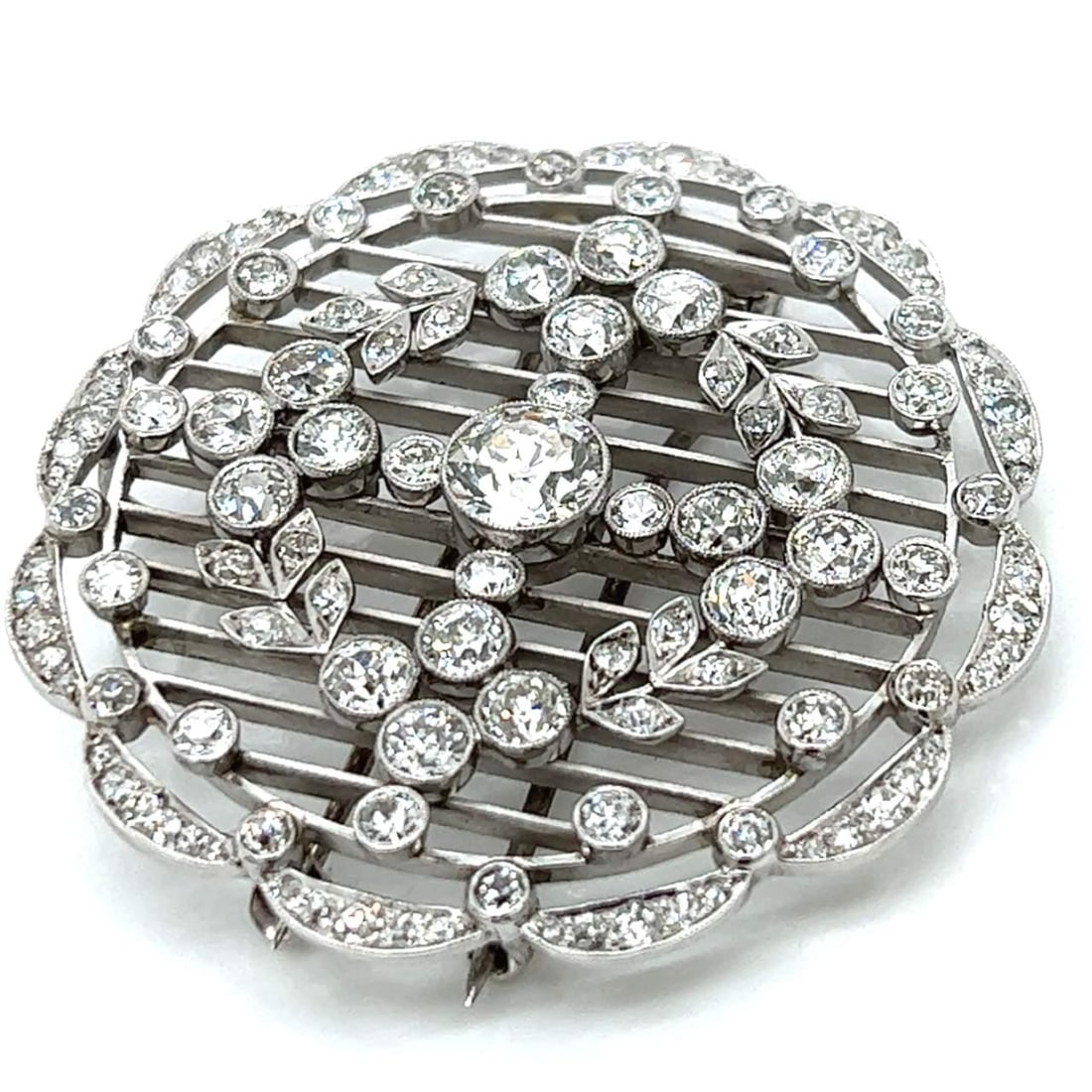 Art Deco Platinum Brooch 7.70 Ct Diamonds 1.20 Ct Center Stone: Art Deco Platinum Brooch 7.70 Ct Diamonds 1.20 Ct Center Stone This exquisite Art Deco brooch is crafted from platinum and showcases a stunning total diamond weight of 7.70 ct. It features an approxim