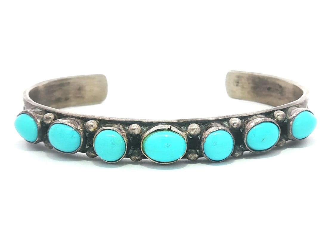 Navajo LLK Sterling Silver Turquoise Open Cuff Bangle Bracelet: Navajo LLK Sterling Silver Turquoise Open Cuff Bangle Bracelet This exquisite Native American Navajo cuff bangle bracelet showcases the beauty of natural turquoise. The bracelet features seven stunnin