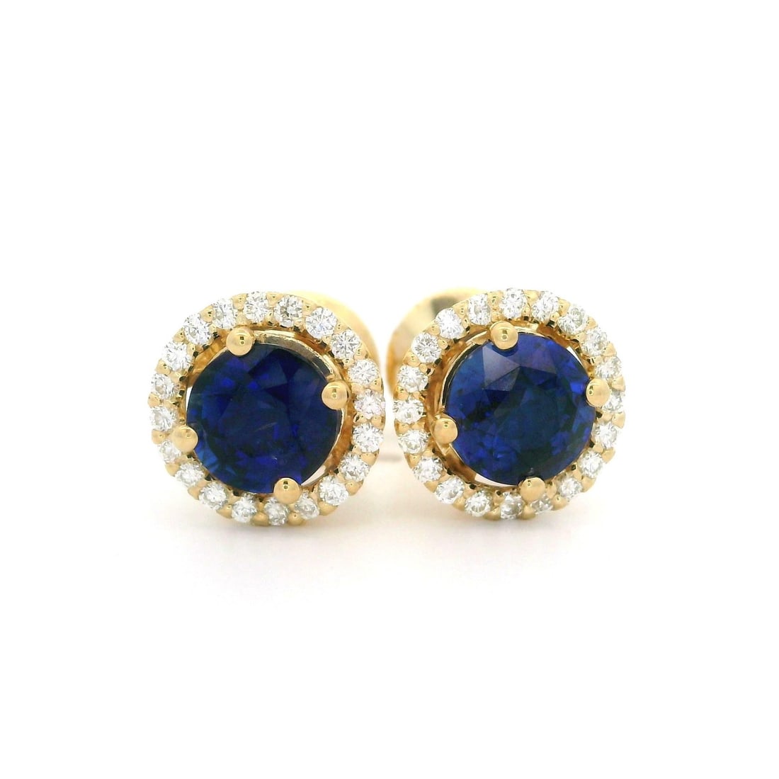 14k Yellow Gold 2.51ctw Sapphire Diamond Halo Stud Earrings: 14k Yellow Gold 2.51ctw Sapphire Diamond Halo Stud Earrings These stunning stud earrings feature a beautiful halo design, crafted from solid 14k yellow gold. Each earring showcases two natural, genuin