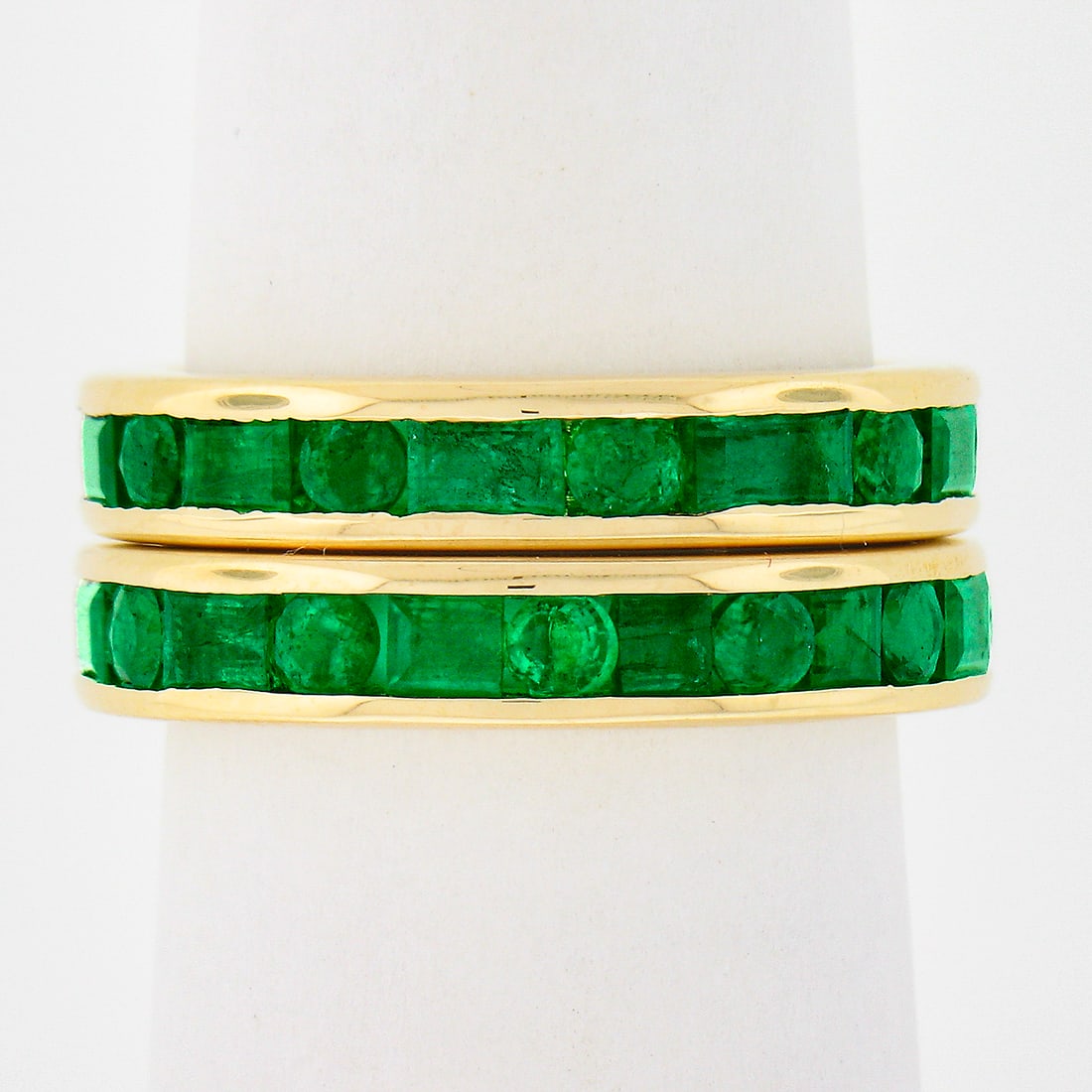 GIA Certified 18k Yellow Gold Emerald Guard Ring Pair: GIA Certified 18k Yellow Gold Emerald Guard Ring Pair This pair of vintage eternity stack band guard rings is crafted from solid 18k yellow gold and features a total of 42 natural, clarity-enhanced em