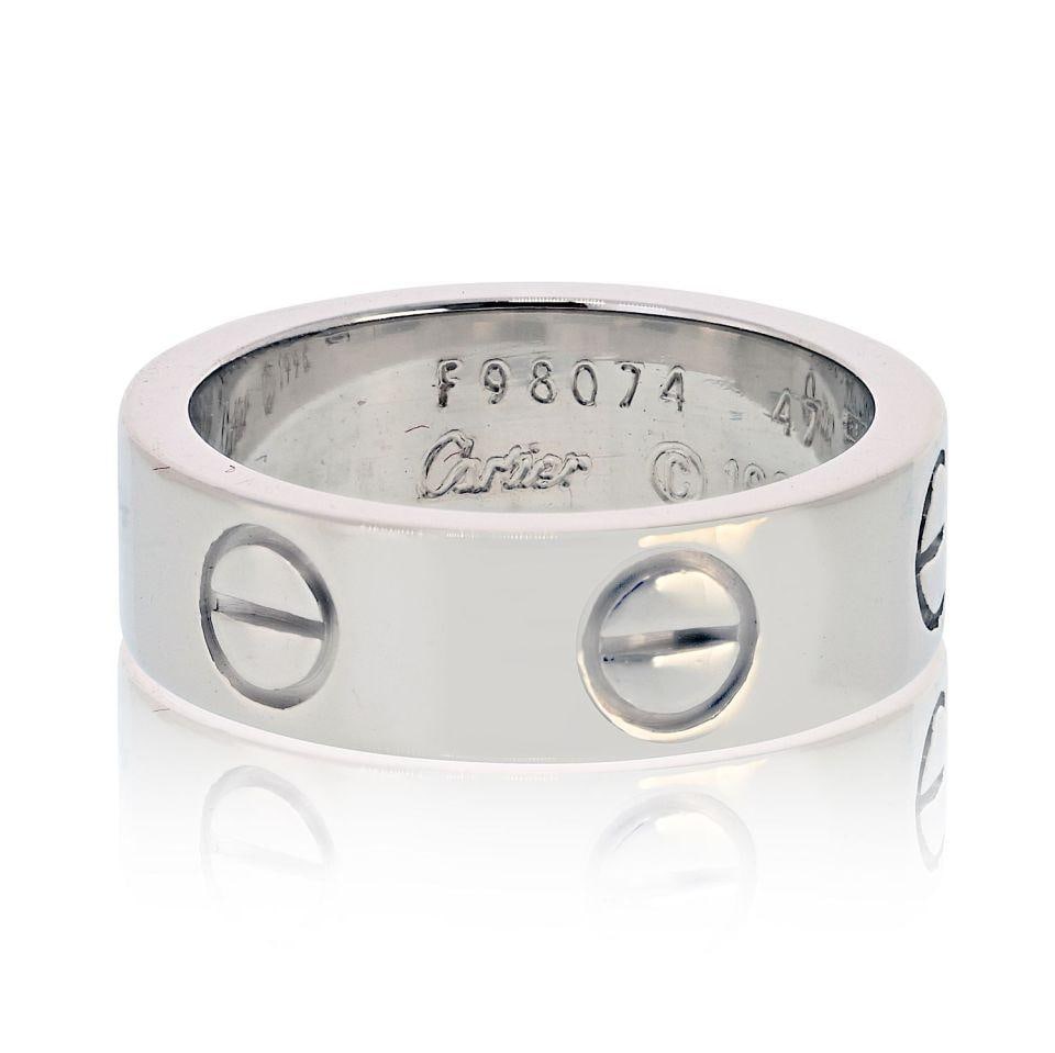 Love Collection Band in 18K White Gold by Cartier Size 47: Love Collection Band in 18K White Gold by Cartier Size 47 This pre-owned Cartier Love ring is crafted from 18K white gold and features the iconic screw motifs that symbolize unity and everlasting love