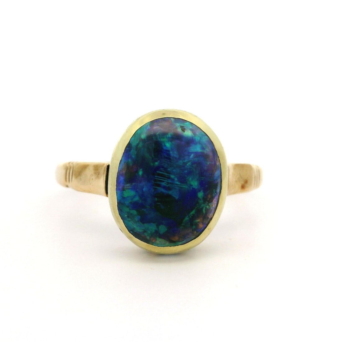 Antique 10k Yellow Gold GIA Certified 3.40ct Black Opal Ring: Antique 10k Yellow Gold GIA Certified 3.40ct Black Opal Ring This exquisite antique ring features a stunning 3.40 ct natural Australian black opal, expertly set in a solid 10k yellow gold bezel. The o