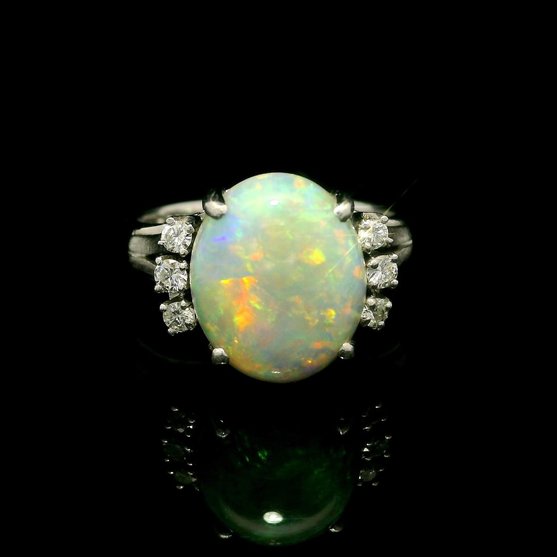 Vintage Platinum 2.51ctw Oval Opal Ring with Diamond Accents: Vintage Platinum 2.51ctw Oval Opal Ring with Diamond Accents This exquisite vintage cocktail ring features a stunning natural genuine opal at its center, showcasing a beautiful oval cabochon cut with 