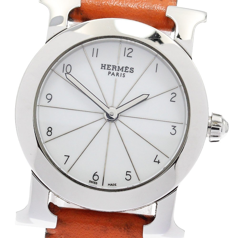 Hermes H-Watch Ronde Quartz Ladies Wristwatch HR1.210: Hermes H-Watch Ronde Quartz Ladies Wristwatch HR1.210 This pre-owned Hermes H-Watch Ronde women's wristwatch features a stainless steel case with a white dial and quartz movement. The watch is paired 