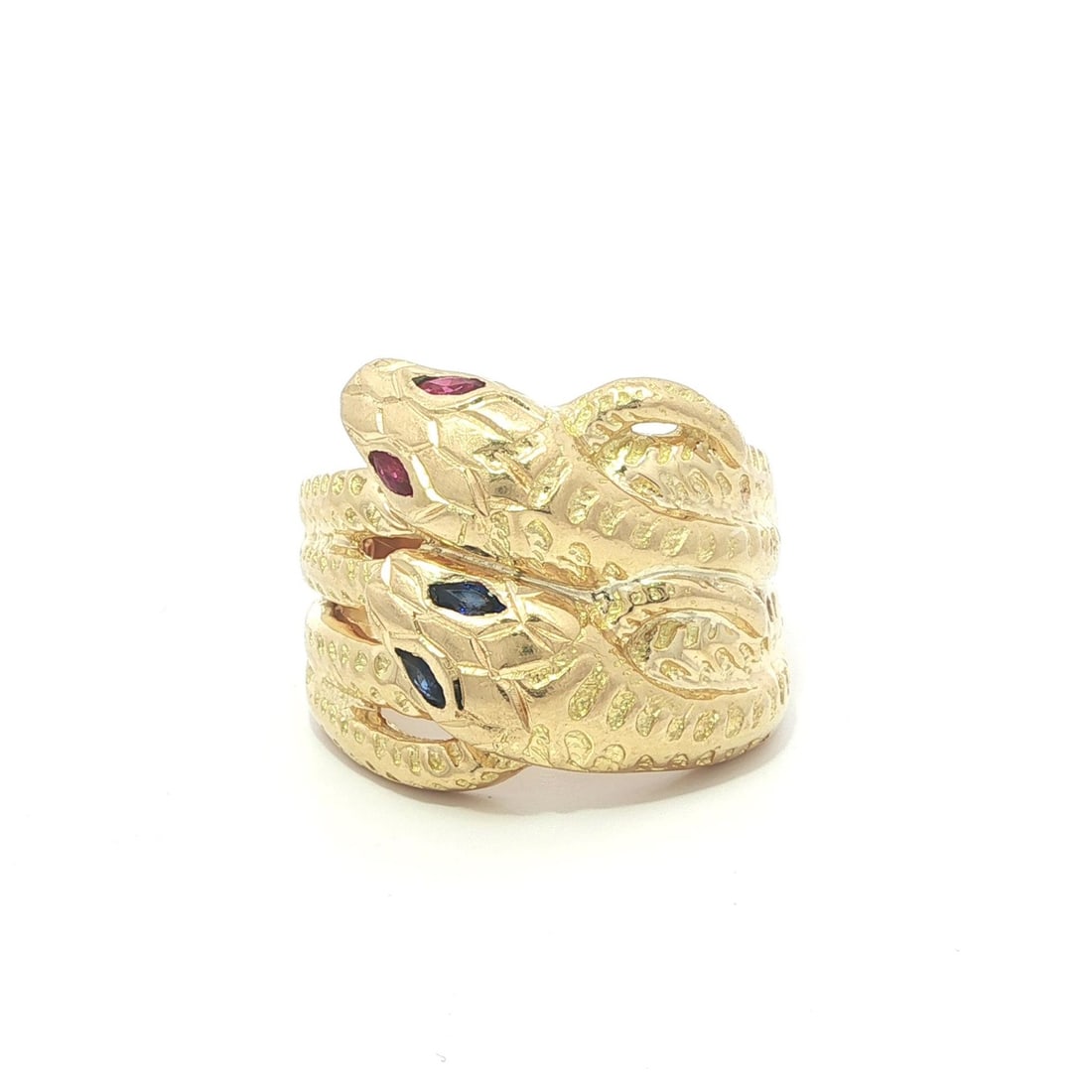 Wide 18k Yellow Gold Snake Ring with Sapphire and Ruby Marquise Eyes: Wide 18k Yellow Gold Snake Ring with Sapphire and Ruby Marquise Eyes This vintage wide band ring features a detailed dual snake design crafted in solid 18k yellow gold. The ring is set with two natura