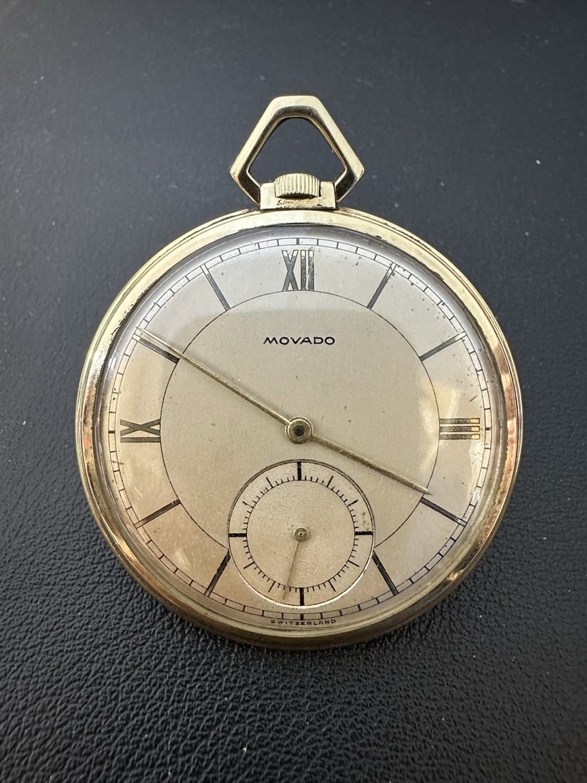 Vintage Movado 14k Yellow Gold 45mm Open Face Pocket Watch: Vintage Movado 14k Yellow Gold 45mm Open Face Pocket Watch Discover the elegance of the Vintage Swiss Movado Factories 14k Yellow Gold Pocket Watch. This exquisite timepiece features a mechanical manu