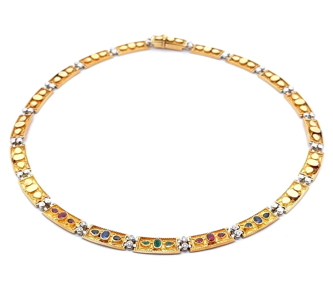 Vintage 18k Gold Necklace with Emerald Ruby Sapphire and Diamonds: Vintage 18k Gold Necklace with Emerald Ruby Sapphire and Diamonds This exquisite vintage necklace showcases a stunning array of natural gemstones set in solid 18k yellow gold. The design features an e
