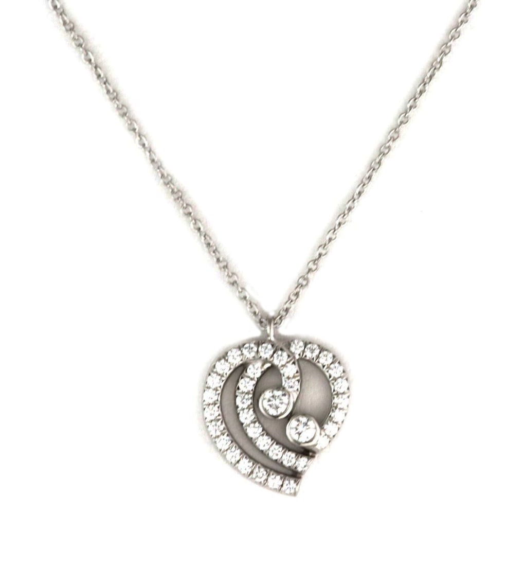 Tiffany & Co. Enchant Platinum Heart Pendant Necklace with Diamonds: Tiffany & Co. Enchant Platinum Heart Pendant Necklace with Diamonds A Tiffany & Co. Enchant heart pendant necklace crafted in platinum and accented with diamonds totaling approximately 0.25 ct. The ne