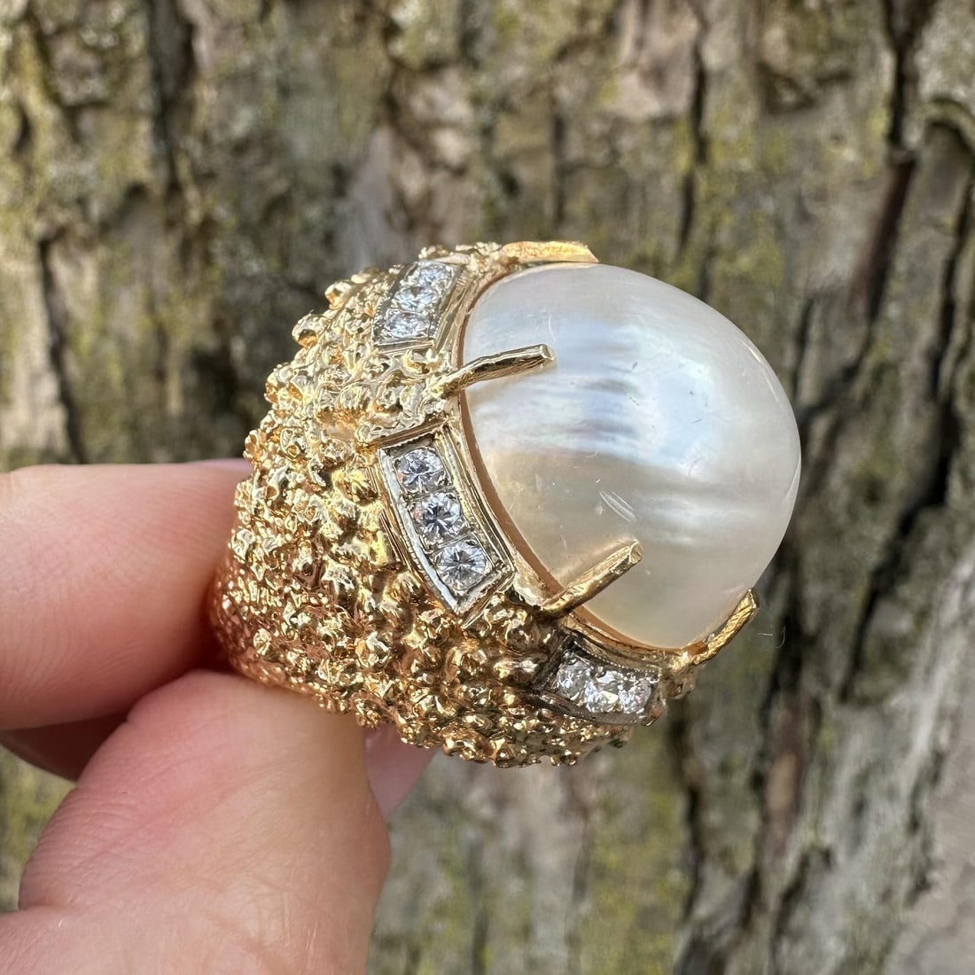 14k Yellow Gold Cocktail Ring with Large Mabe Pearl and Diamond Accents: 14k Yellow Gold Cocktail Ring with Large Mabe Pearl and Diamond Accents This vintage cocktail ring features a large, genuine cultured Mabe pearl with a light pink overtone, set in solid 13-14k yellow 
