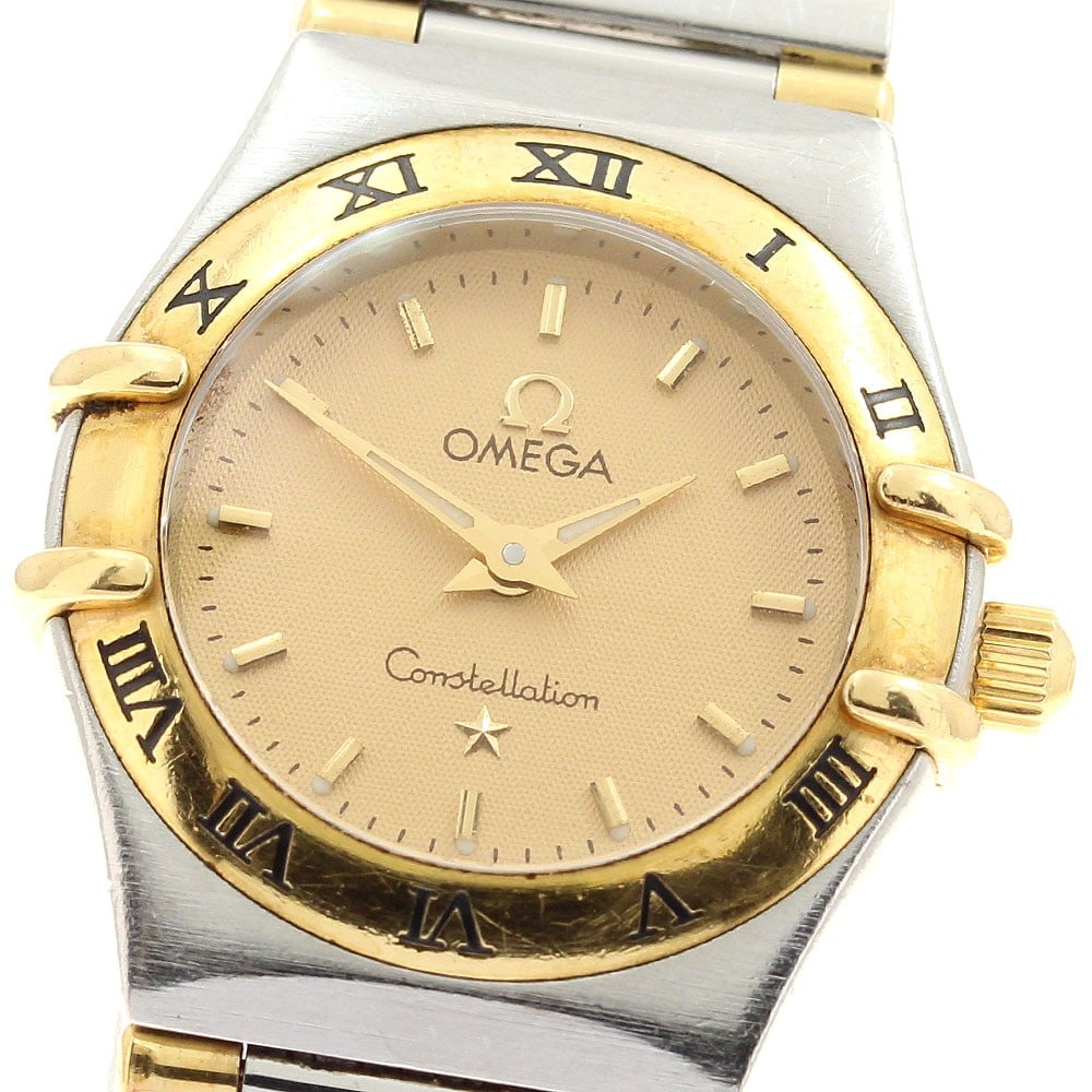 OMEGA Constellation Mini Quartz Ladies Wristwatch YG Bezel Half Bar: OMEGA Constellation Mini Quartz Ladies Wristwatch YG Bezel Half Bar This OMEGA Constellation Mini wristwatch features a yellow gold bezel and half bar design. Made in Switzerland, this quartz watch is