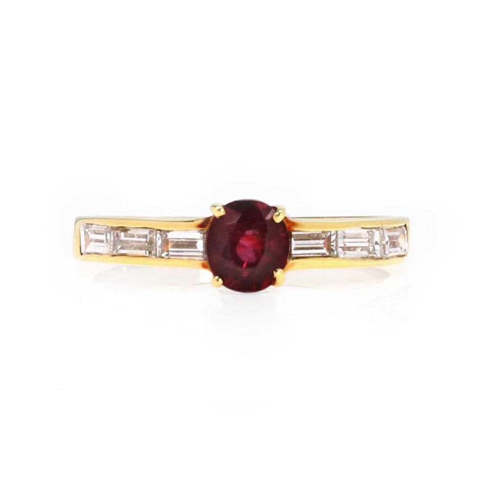 Elegant 18k Yellow Gold Diamond Ruby Cocktail Ring: Elegant 18k Yellow Gold Diamond Ruby Cocktail Ring This stunning Diamond and Ruby Solitaire Ring showcases an exquisite oval-shaped ruby at the center, elegantly complemented by three elongated baguet