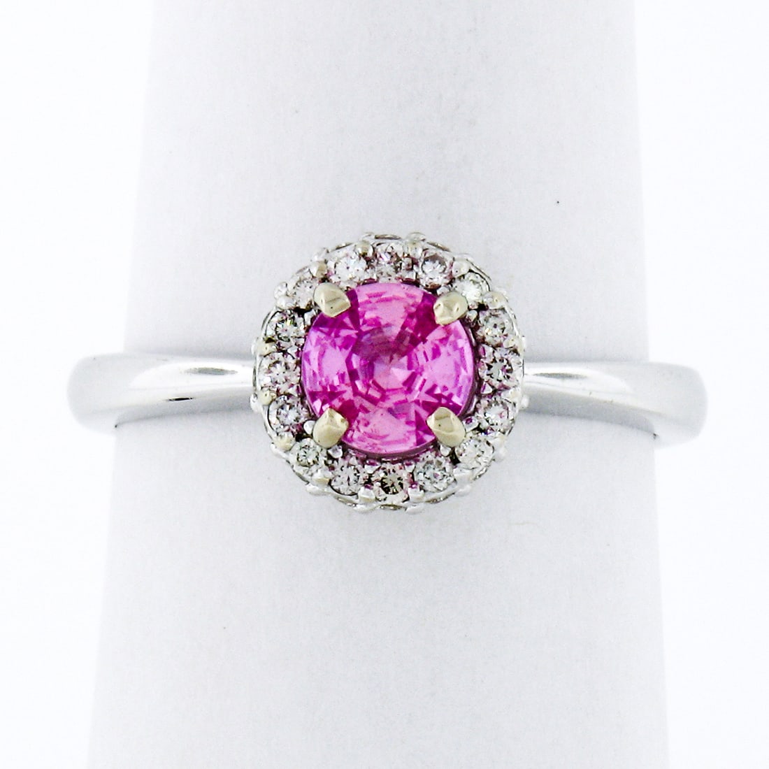 14K White Gold 1.40ct Pink Sapphire Diamond Halo Engagement Ring: 14K White Gold 1.40ct Pink Sapphire Diamond Halo Engagement Ring This exquisite engagement ring features a stunning 1.40ct round pink sapphire at its center, elegantly surrounded by a halo of 61