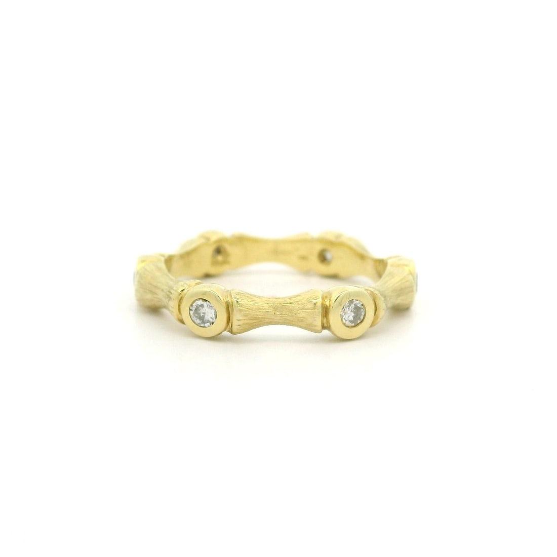 Bamboo Style 14k Yellow Gold Band Ring with 0.20ctw Bezel Set Diamonds: Bamboo Style 14k Yellow Gold Band Ring with 0.20ctw Bezel Set Diamonds This women's band ring is crafted in solid 14k yellow gold with a textured bamboo-style finish and bezel-set natural diamonds. It