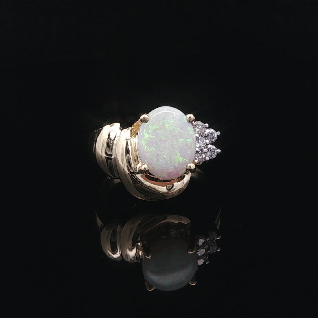 Cabochon Opal and Diamond Cocktail Ring in 14k Yellow Gold Size 6: Cabochon Opal and Diamond Cocktail Ring in 14k Yellow Gold Size 6 This cocktail ring features a natural oval cabochon opal prong-set in solid 14k yellow gold, accented with five round brilliant-cut na