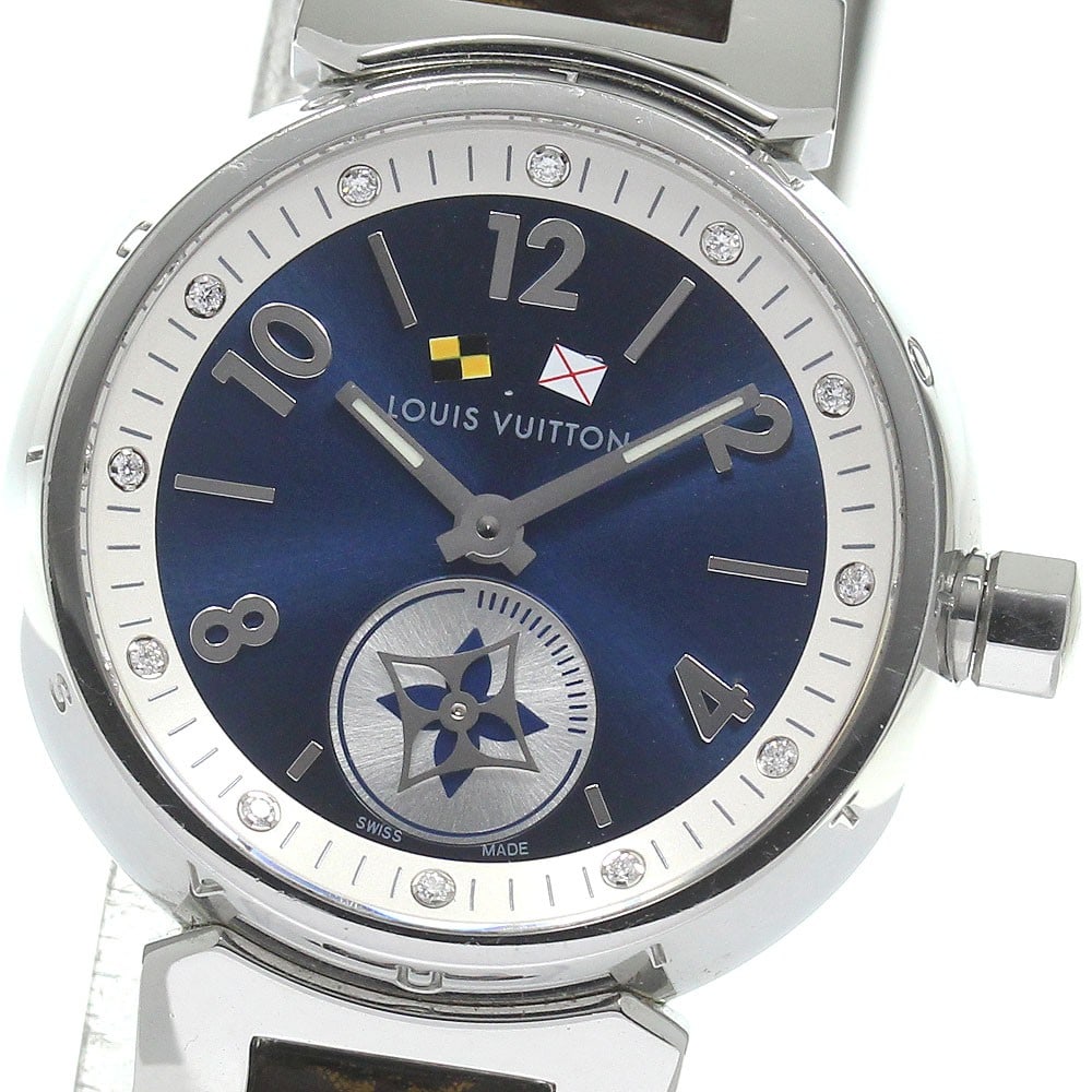 Louis Vuitton Tambour Q12MP Quartz Ladies Wristwatch: Louis Vuitton Tambour Q12MP Quartz Ladies Wristwatch This Louis Vuitton Tambour Q12MP is a pre-owned women's wristwatch featuring a stainless steel case and a blue dial. The watch is powered by a quar