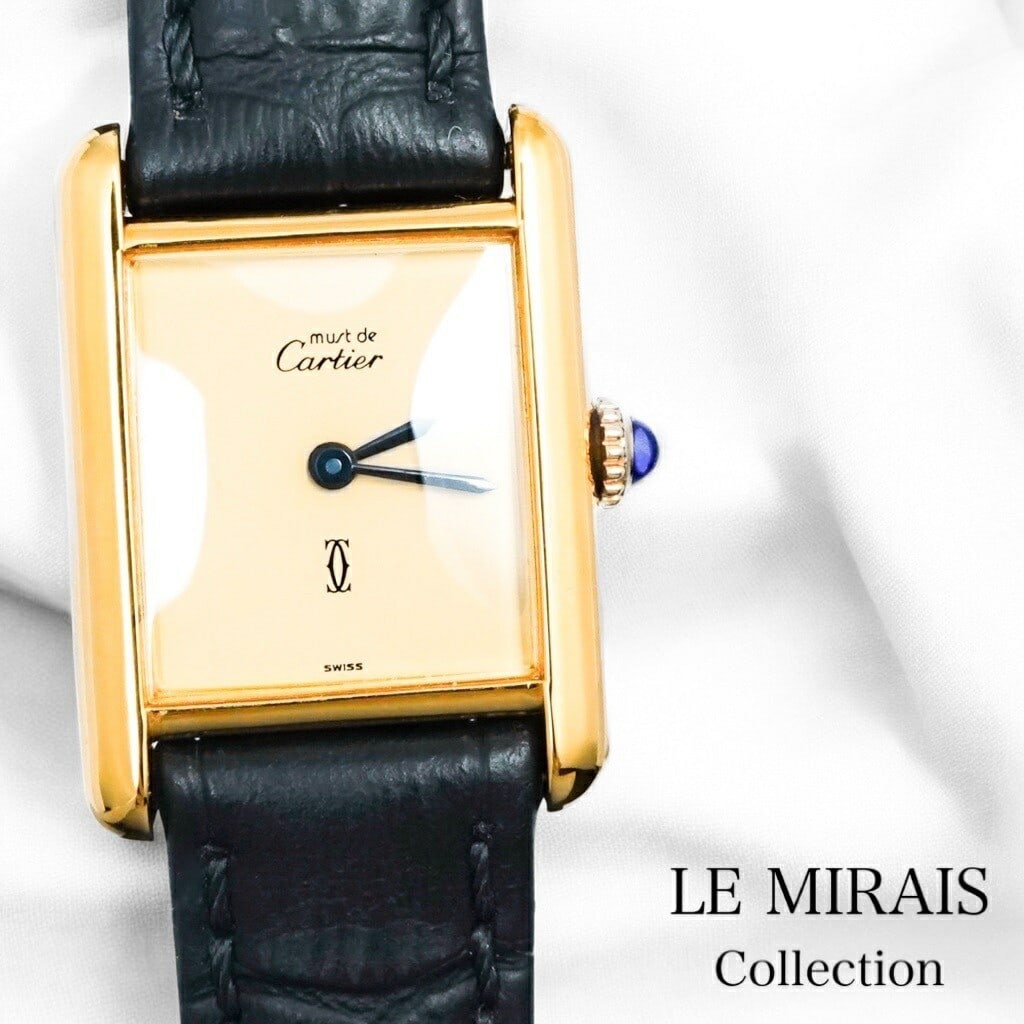 Cartier Must Tank SM Gold Ladies Manual Wind Watch Beige Dial Strap: Cartier Must Tank SM Gold Ladies Manual Wind Watch Beige Dial Strap This Cartier Must Tank SM is a classic hand-winding ladies wristwatch featuring a beige dial and gold-tone case. The watch is pre-ow