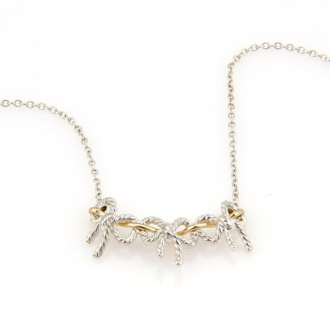 Tiffany & Co. Bow Pendant Necklace in Sterling Silver & 18k Yellow Gold: Tiffany & Co. Bow Pendant Necklace in Sterling Silver & 18k Yellow Gold Elevate your jewelry collection with this exquisite Tiffany & Co. Bow Pendant Necklace. Crafted from high-quality sterling silve